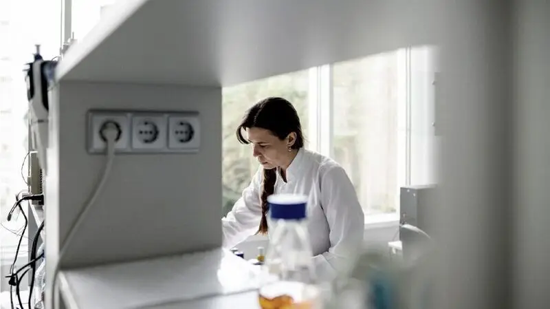 A female lab technician works in a lab