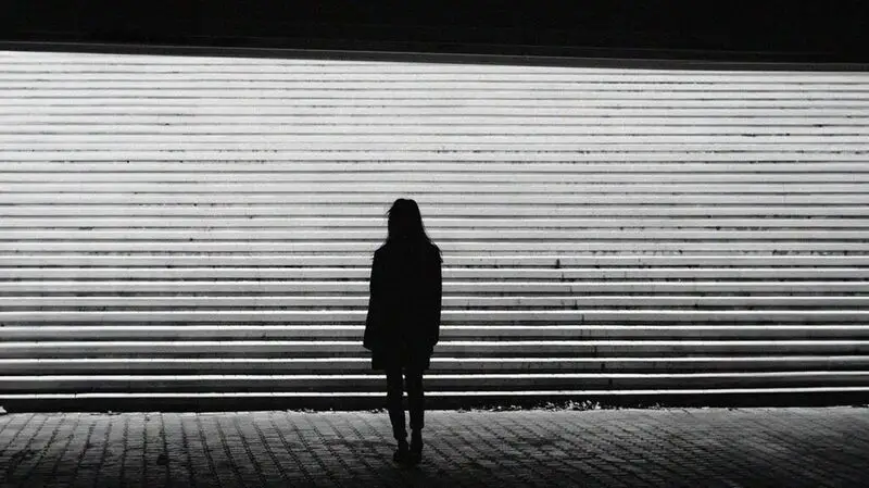 The silhouette of a woman near some concrete steps