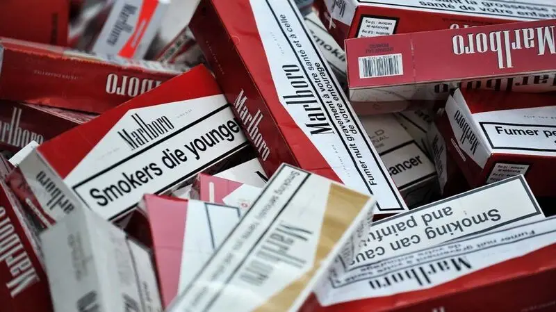 Cartons of cigarettes lay on a table