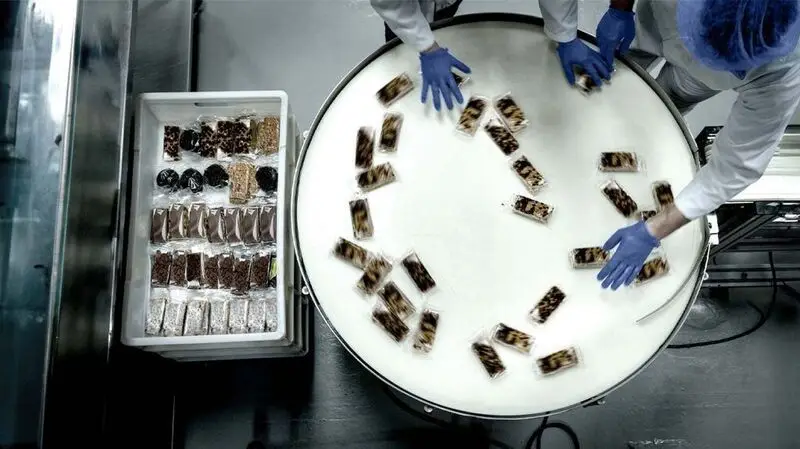 food factory workers sorting mass-produced sweets