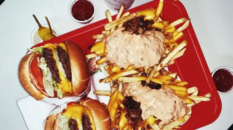 Cheeseburgers and fries on a food tray