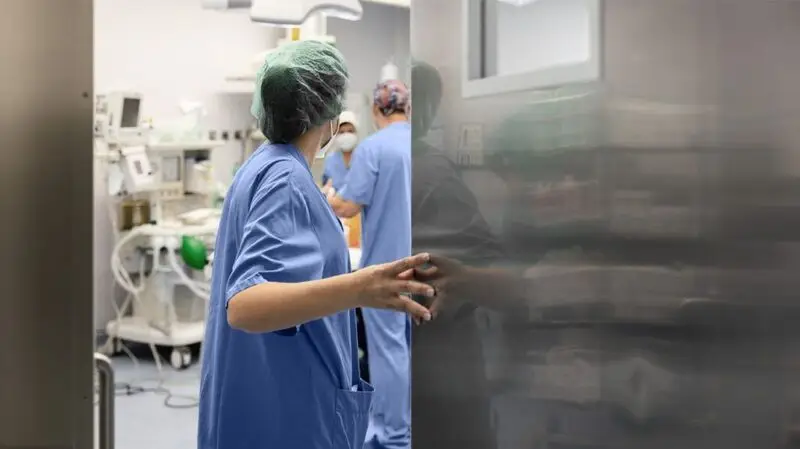 Surgeons and healthcare professionals inside an operating room at a hospital
