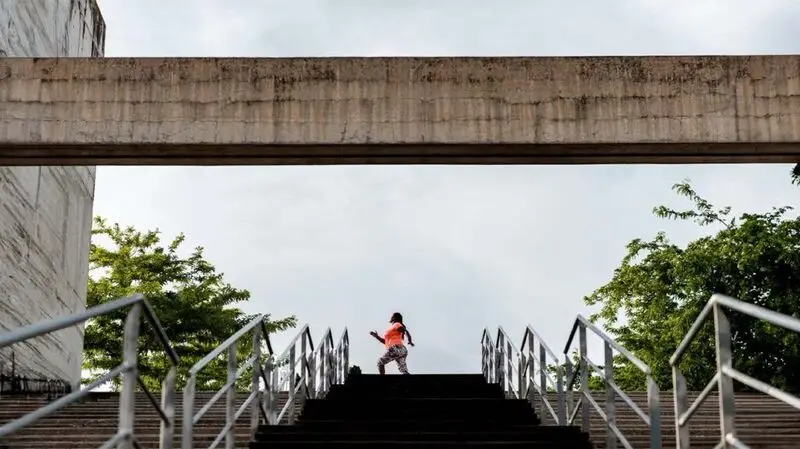 Female exercising on stairs outdoors