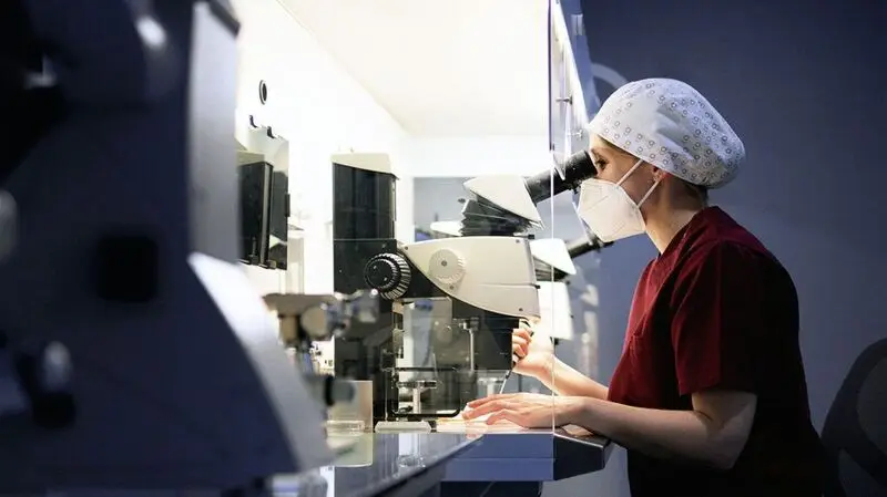 A scientist sitting and analyzing samples at a laboratory