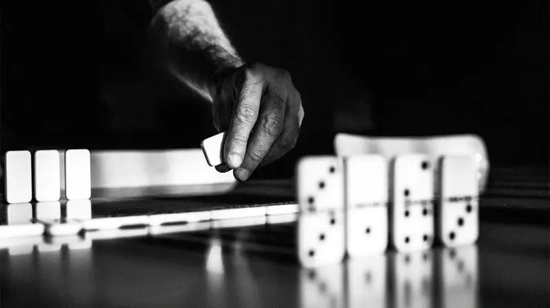 A person laying down domino tiles