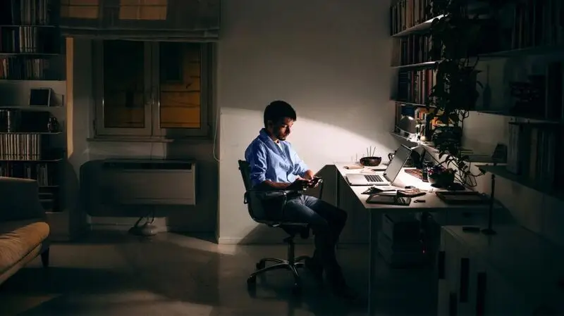 man working in an office in the evening