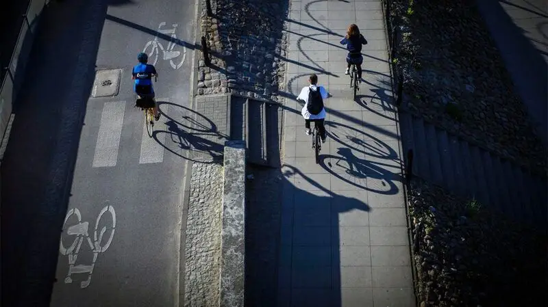 A bird's eye view of people riding their bikes and exercising outside