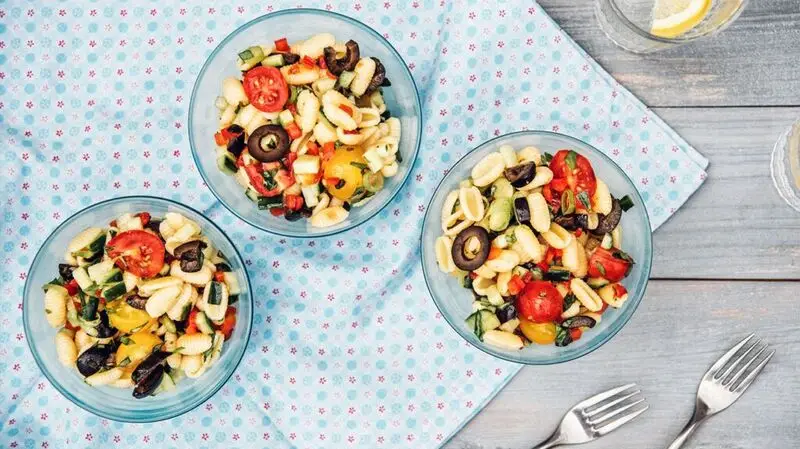 three bowls of pasta salad