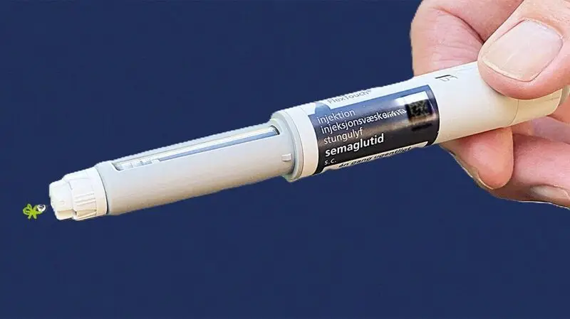 semaglutide injection pen against blue background