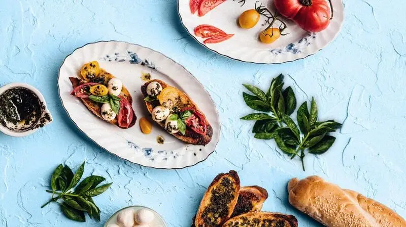 bruschetta, tomatoes, sprig of basil, seeded bread