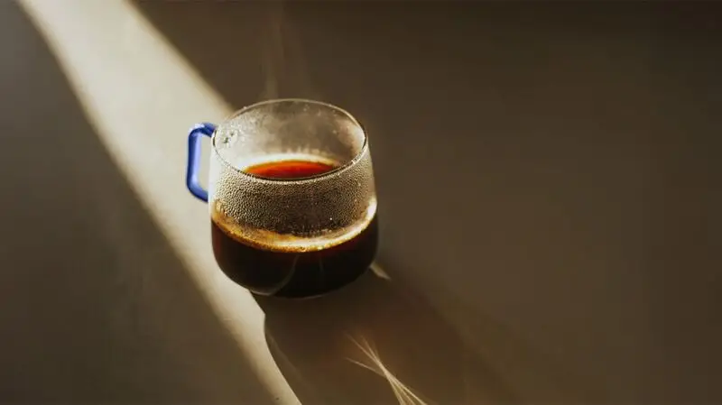 clear coffee cup in a cone of light