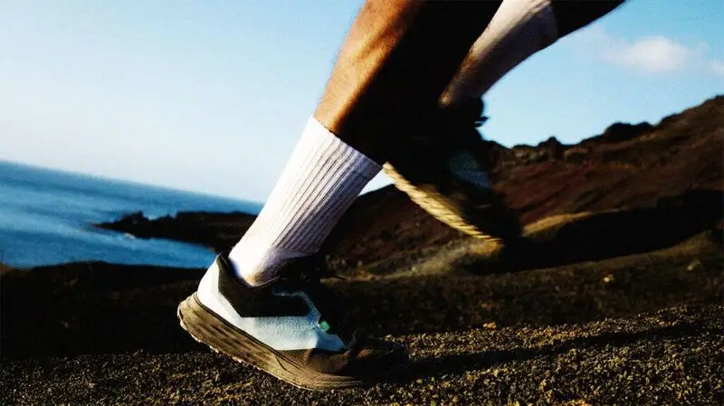 close-up of feet running on rough terrain