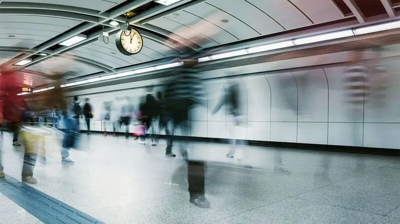 A long exposure image of people commuting in the subway during rush hour