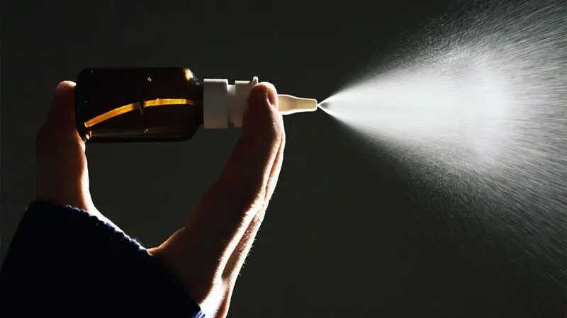 nasal spray against dark background