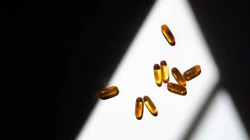 capsules of omega-3 in cone of light