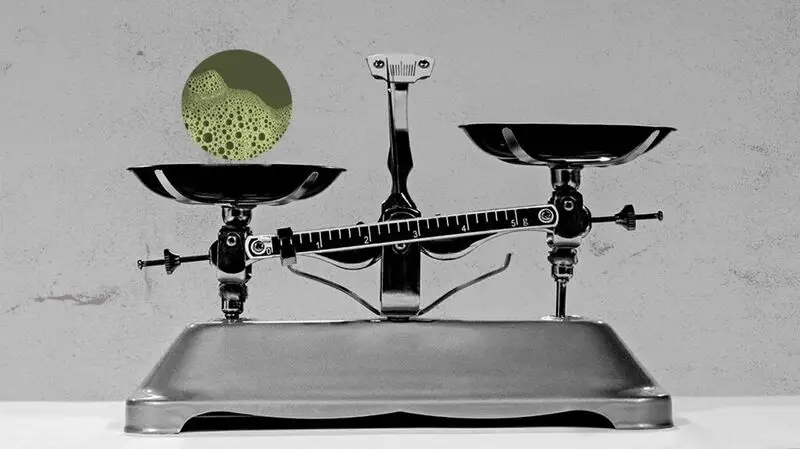 illustration of old-fashioned scales weighed down by bacterial sample, suggesting bacterial imbalance