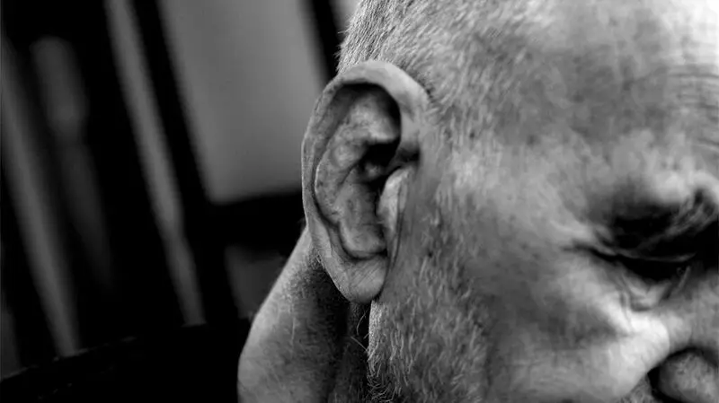 black and white close-up photo of man's ear