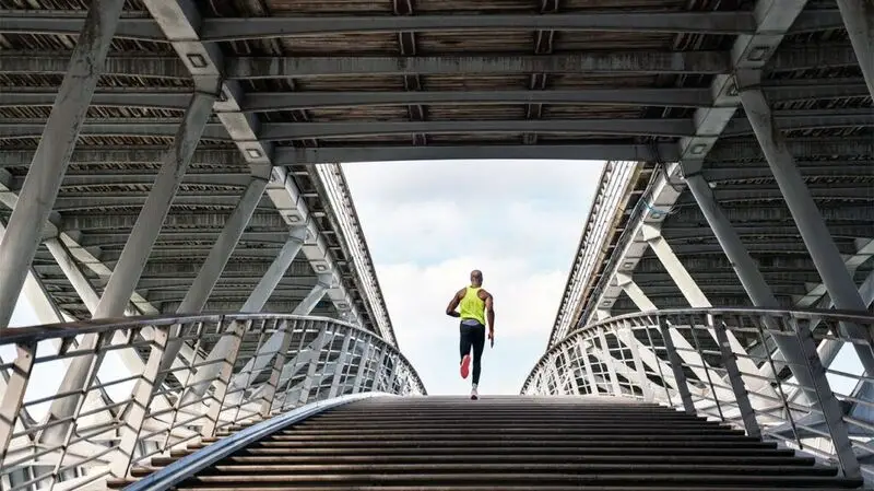 person jogging across bridge