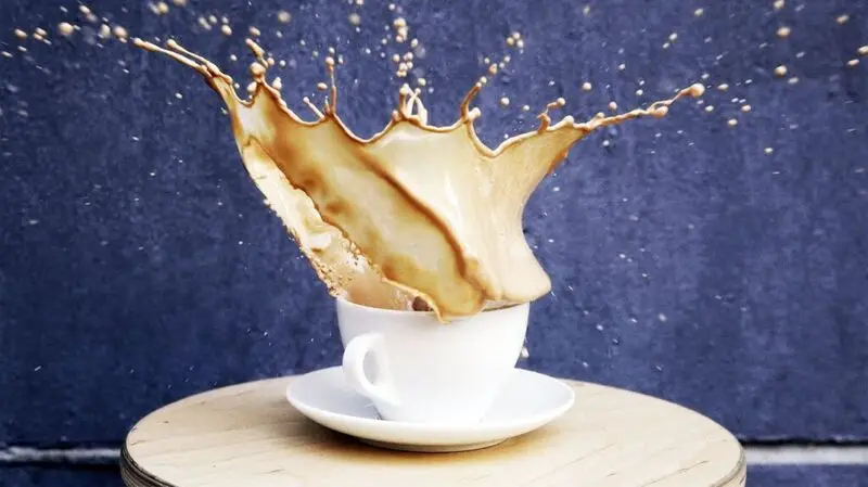 coffee splashing from white cup