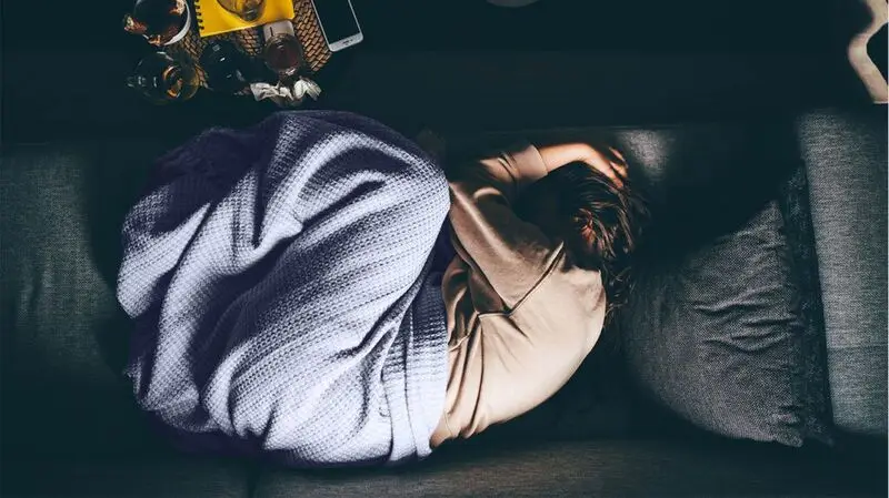 person napping on sofa