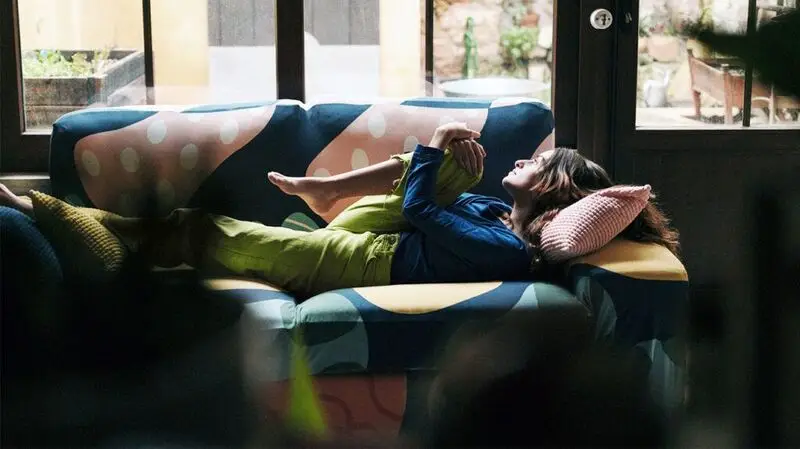 person lounging on the sofa, daydreaming