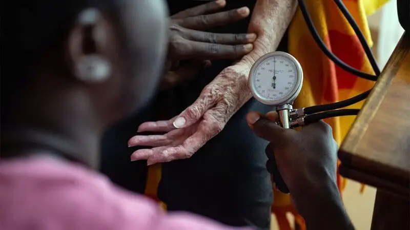 doctor measuring person's blood pressure