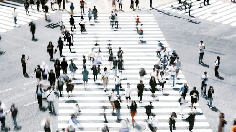 distorted birds-eye view image of people on a crossing