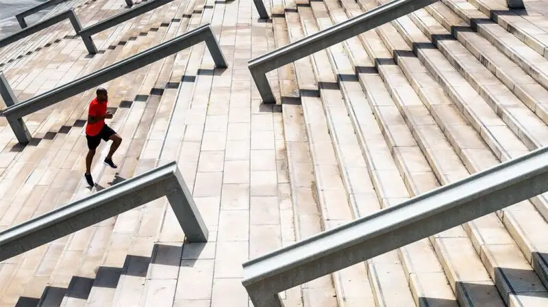 Black man running up a flight of stairs