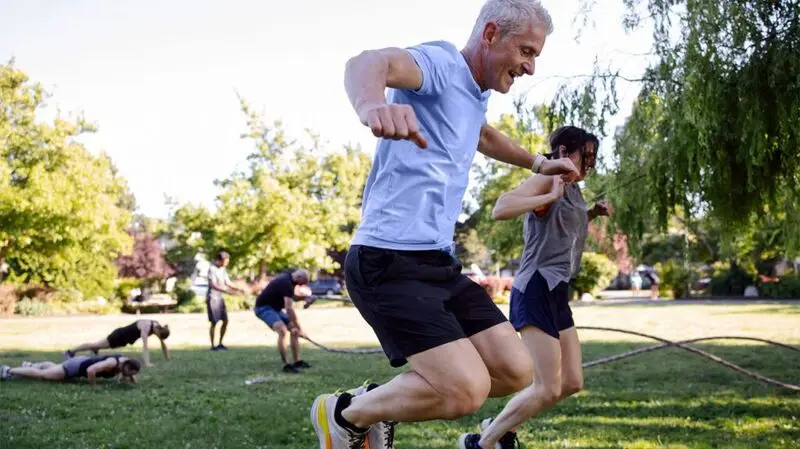 older people playing sports in park