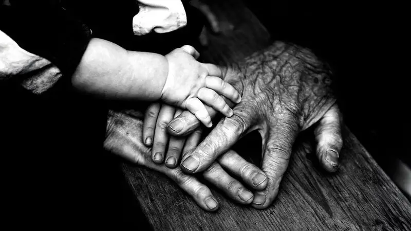 hands of people of different ages touching