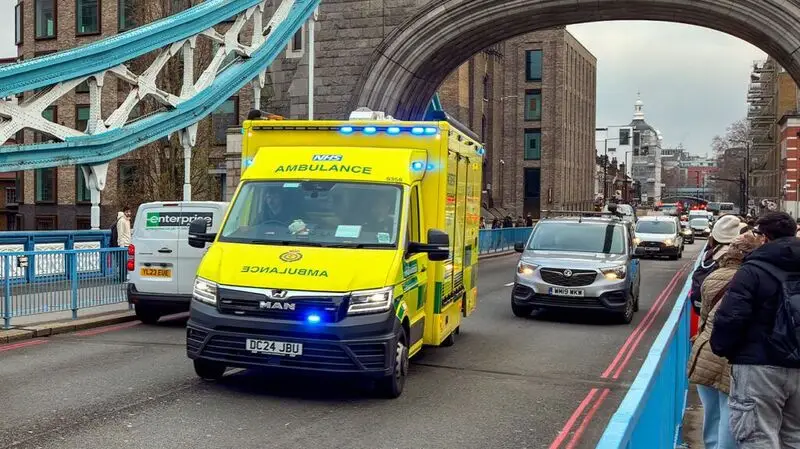 Ambulance driving over Tower Bridge in London