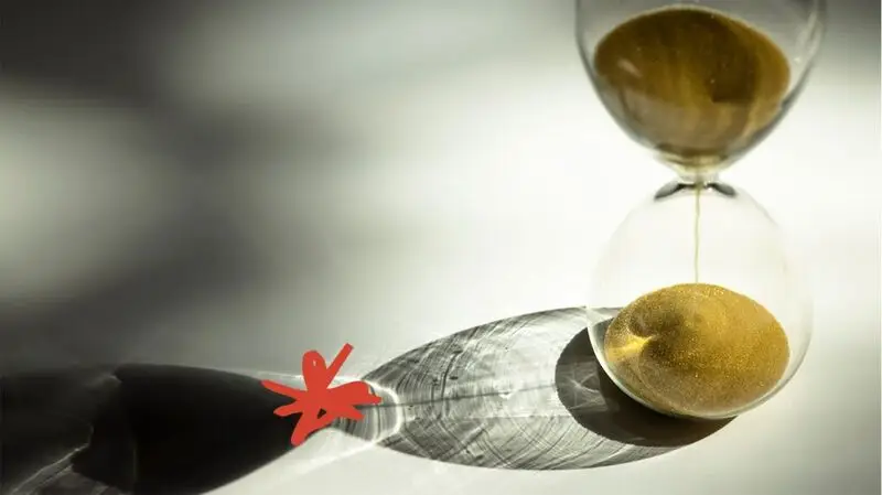 hourglass with long shadow