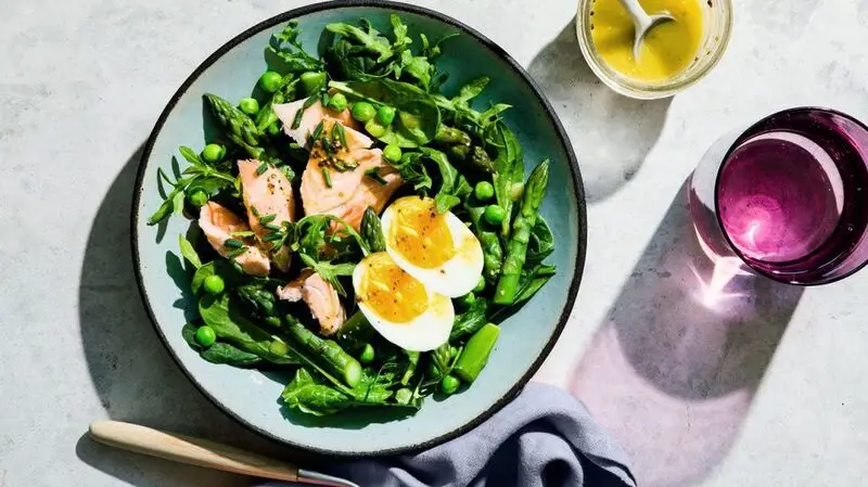 plate of salmon, egg, asparagus, and leafy greens