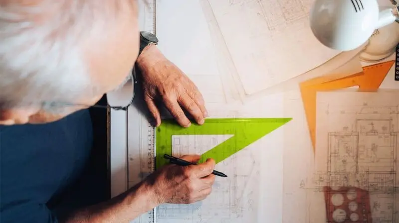 older white man drawing lines with a set triangle