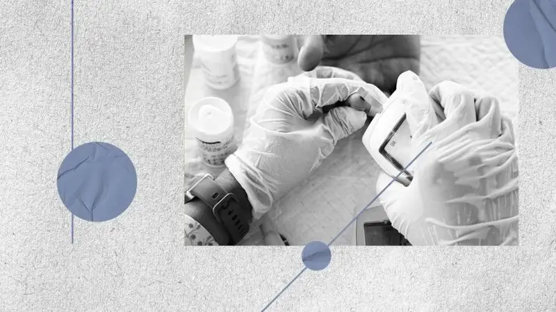 hands wearing medical gloves handling cholesterol test