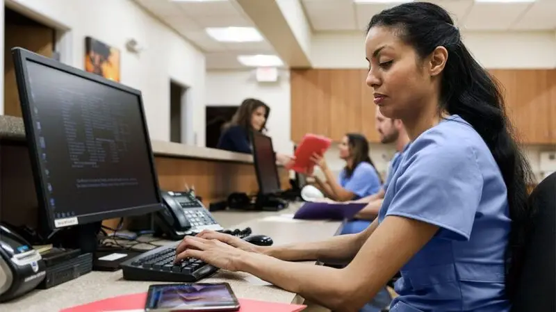A healthcare professional using a computer.