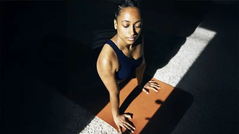 Black woman doing yoga or stretches