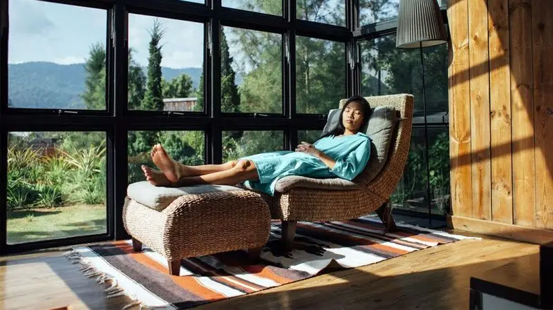 A person having a nap in a chair.