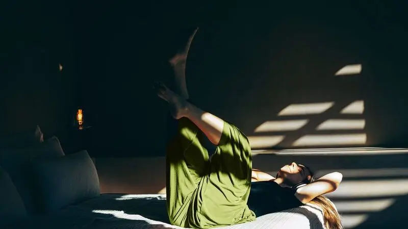 A person exercising while lying on their back.