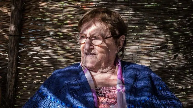 portrait of older white woman with short brown hair and glasses