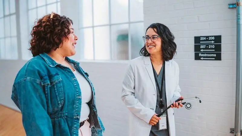 A healthcare professional talking with a patient.