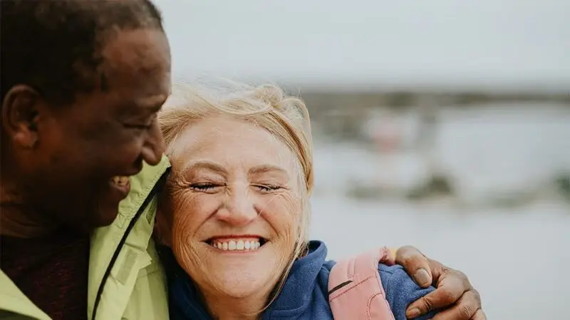 Two people embracing, with the focus on a female presenting individual. 
