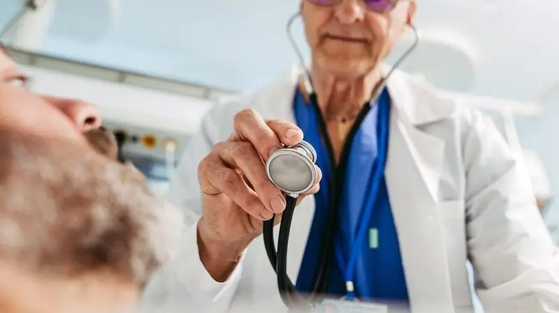 A doctor using a stethoscope.