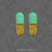 Minocycline (systemic) (monograph) (Dynacin)-59911 5870-100 mg-Green & Yellow-Capsule-shape