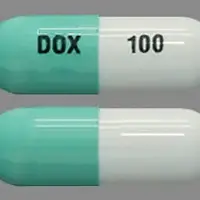 Doxepin (systemic) (monograph) (Sinequan)-DOX 100-100 mg-Green & White-Capsule-shape